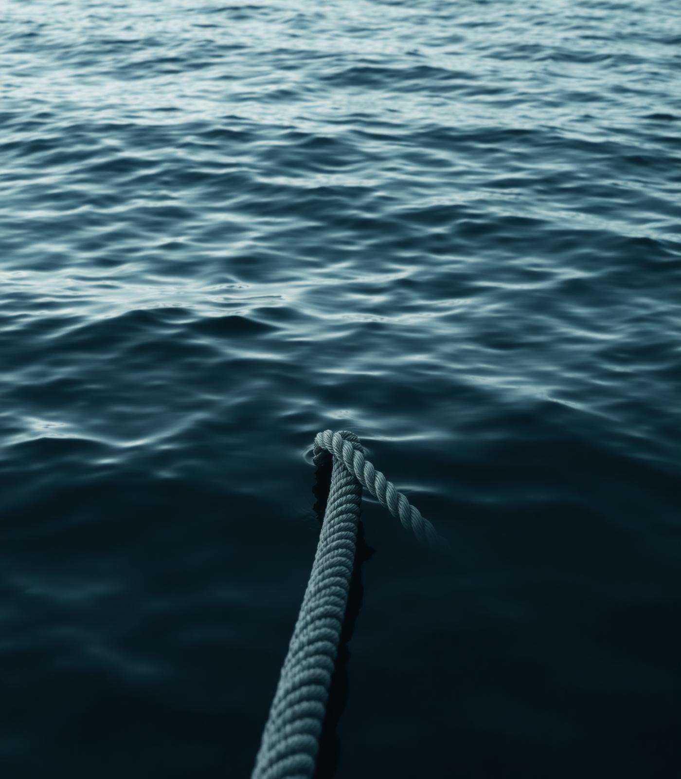 Harbor rope over calm water